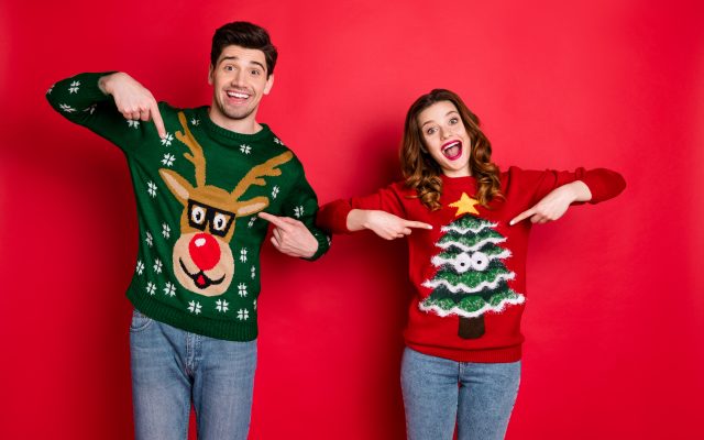 Man and woman wearing Christmas jumpers